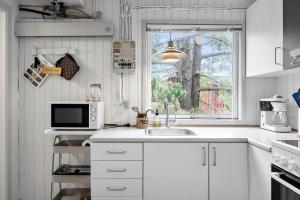 a white kitchen with a sink and a window at 329-Thisted-Sandtornvej-21 in Thisted +13 photos