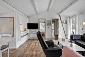 a living room with black chairs and a television at 329-Thisted-Sandtornvej-21 in Thisted