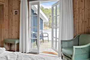 a bedroom with a bed and a sliding glass door at 329-Thisted-Sandtornvej-21 in Thisted