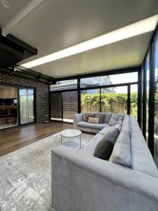 a living room with a large couch and a table at Matthews Green fall House in Sunshine