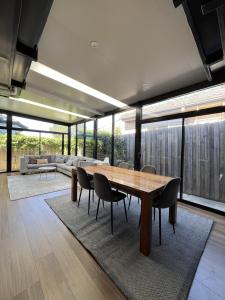 a large living room with a wooden table and chairs at Matthews Green fall House in Sunshine