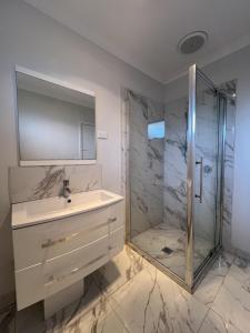 a bathroom with a sink and a shower at Matthews Green fall House in Sunshine +20 photos