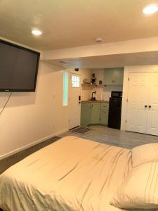 a bedroom with a large bed and a flat screen tv at Green Clover Hideaway in Draper