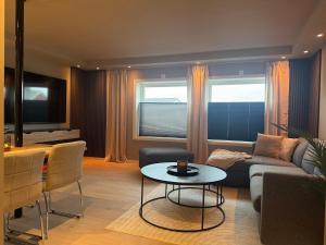 a living room with a couch and a table at Villa Nyheim in Florø