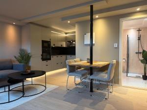 a kitchen and living room with a table and chairs at Villa Nyheim in Florø