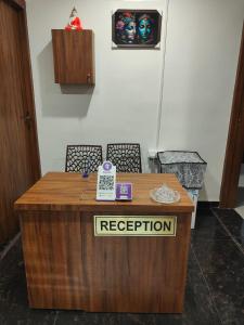 a reception desk with a phone on top of it at Hotel Shree Krishnam, Kota in Kota