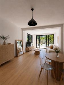 a living room with a couch and a table at Maison Plumeria in Triel-sur-Seine