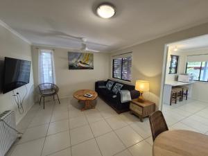 a living room with a couch and a table at Rainbow Heights 2 Bed Apartment in Rainbow Beach