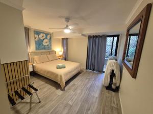a bedroom with a bed and a ceiling fan at Rainbow Heights 2 Bed Apartment in Rainbow Beach