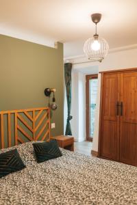 a bedroom with a bed and a lamp and a window at Chez Gabriel et Sophie in Pérouges