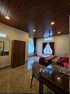a bedroom with a bed and a wooden ceiling at Pine ridge homestay kuttikanam in Pīrmed