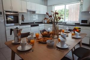 a kitchen with a wooden table with food on it at La Marisol Ribeira in Ribeira
