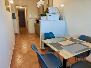 a dining room with a table and blue chairs at La Casa di Stefy - affittacamere in Cammarata