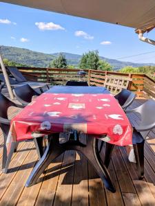 a table and chairs on a deck with a view at Gîte FRAIZE in Fraize +9 photos