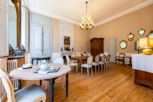 a kitchen and dining room with a table and chairs at Château Puybarban in Puybarban