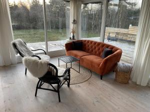 a living room with a couch and two chairs at Charming House Close To The Beach in Gedser +32 photos