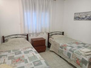 two beds sitting next to each other in a bedroom at Alexia's House in Leptokarya
