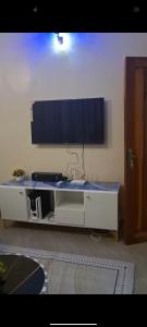 a white desk with a large monitor on a wall at One bedroom in Narok