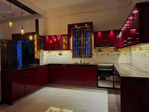 a kitchen with red cabinets and a sink at Trinco Harbour Villa in Trincomalee