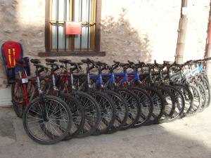 a row of bikes parked next to a wall at La Cuculla in Ezcaray