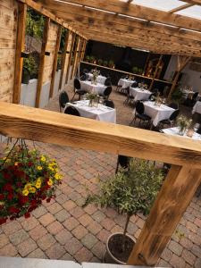 an outdoor patio with tables and chairs and flowers at Frischbier's Gästezimmer in Schmelz-Primsweiler