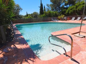 a swimming pool with a metal rail next to it at Apartamento I Els Cucons in Sant Pere de Ribes