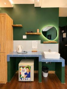 a play kitchen with a sink and a counter at Ben Thanh Hideaway - A Cozi Stay in Ho Chi Minh City +21 photos