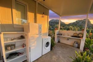 a kitchen with a washer and dryer in a tent at Enjoy the Silence in Marmaris