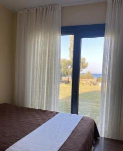 a bedroom with a bed and a large window at Enjoy the Silence in Marmaris