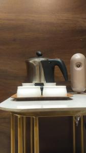 a tea pot sitting on top of a table at Ramona homestay in Kolhapur