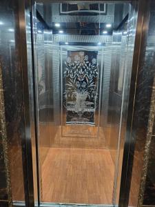 a glass display case with a design on the wall at Hotel Shree Krishnam, Kota in Kota