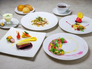 a group of plates of food on a table at Manza Prince Hotel in Tsumagoi
