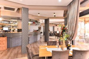 a restaurant with a table and chairs and a bar at комплекс Иван и Петър in Belitsa