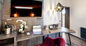 a room with a desk with a laptop on it at PLAZA INN Heilbronn in Heilbronn