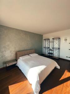 a bedroom with a large bed and two shelves at Residenza Monticelli in Lavagno +21 photos