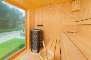 a wooden sauna with a bench and a window at Parkhotel Rügen in Bergen auf Rügen