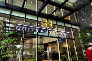 a building with a sign that reads birmingham hotel at Brittany Hotel BGC in Manila