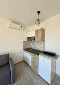 a kitchen with a sink and a couch in a room at Molla Apartments in Ulcinj +45 photos