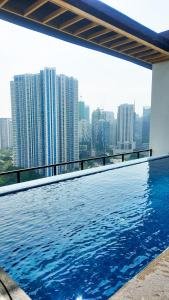 a swimming pool with a view of a city skyline at Brittany Hotel BGC in Manila