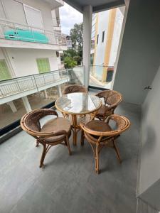 a patio with a table and chairs on a balcony at Sunset Apartment A-3 in Perea