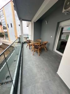 a patio with a table and chairs on a balcony at Sunset Apartment A-3 in Perea +4 photos