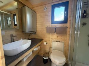a bathroom with a white sink and a toilet at Ezy House by Tiny Away in Ézy-sur-Eure +7 photos