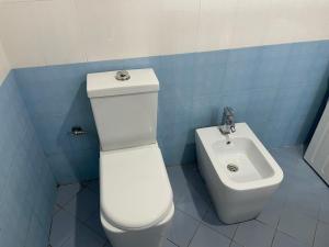 a bathroom with a toilet and a sink at Eretz in Tirana +45 photos