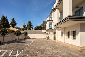 an empty courtyard of a white building at Magnolia in Alicante