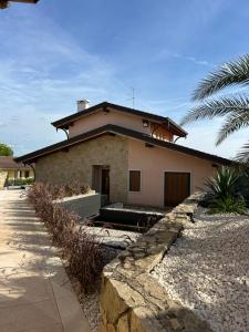 a house with a stone wall in front of it at Residenza Monticelli in Lavagno