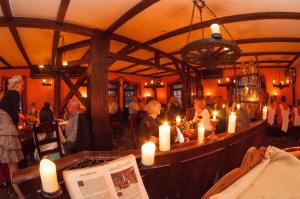 a group of people sitting in a room with candles at Ringhotel Lutherhotel Eisenacher Hof in Eisenach