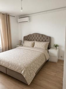 a bedroom with a large bed in a white room at The North Antwerp Apartment in Antwerp