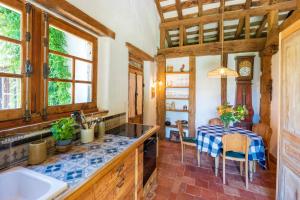 a kitchen with a table with a blue and white table cloth at Dependance avec Jacuzzi in Arcangues