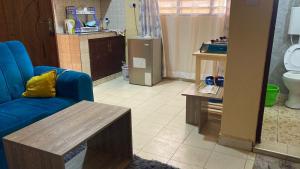 a living room with a blue couch and a table at Margin Diani in Ukunda +40 photos