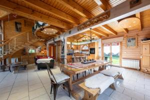 a large living room with a wooden ceiling at Chalet Du Pont Des Fées in Gérardmer